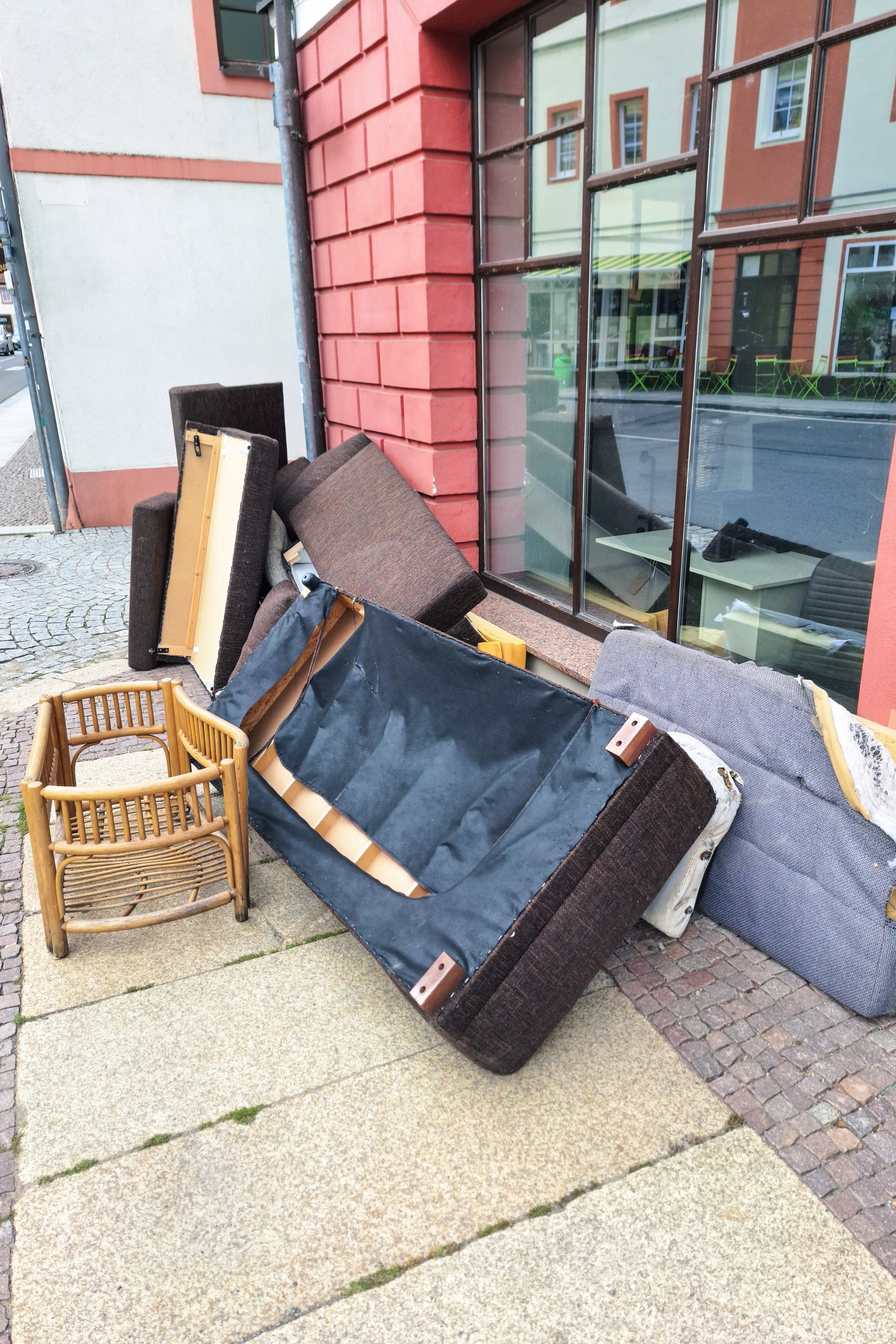 Old furniture pile on sidewalk for pickup