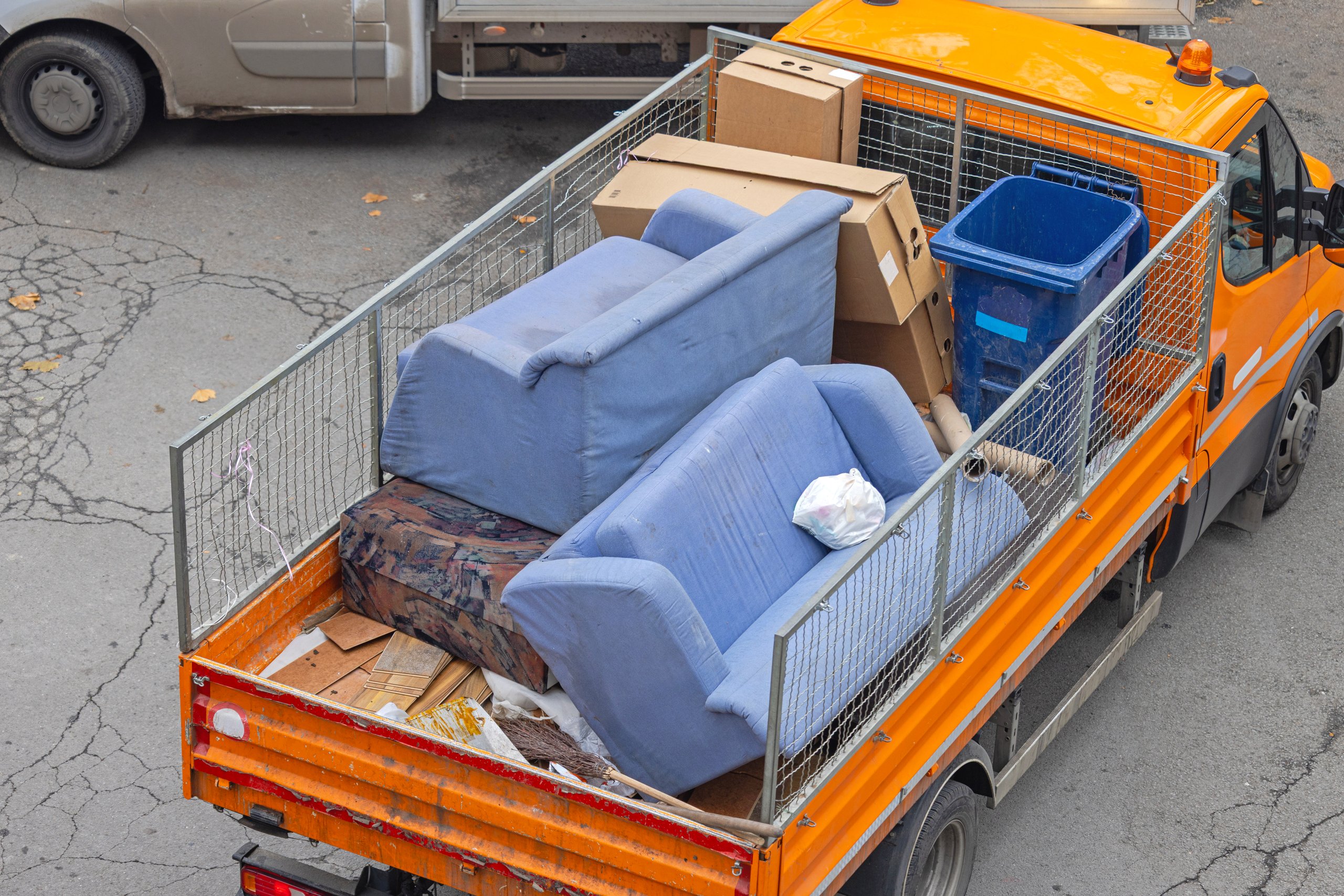 Truck loaded with junk furniture and household items ready for removal