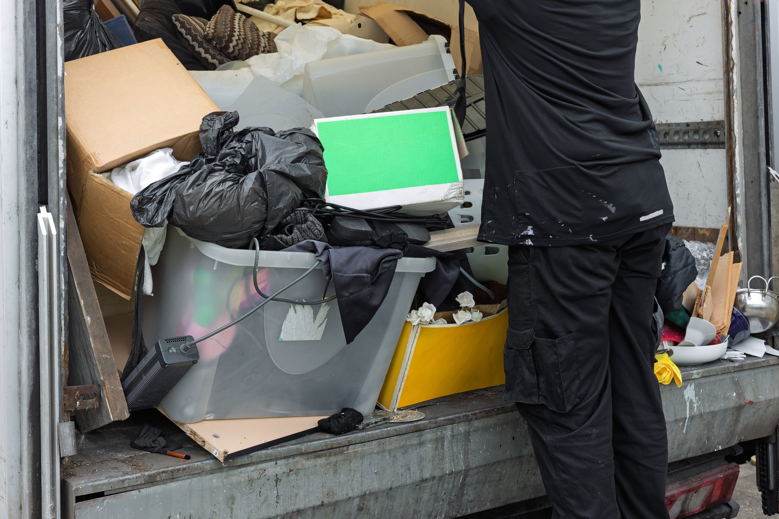 Workers loading junk into truck for removal